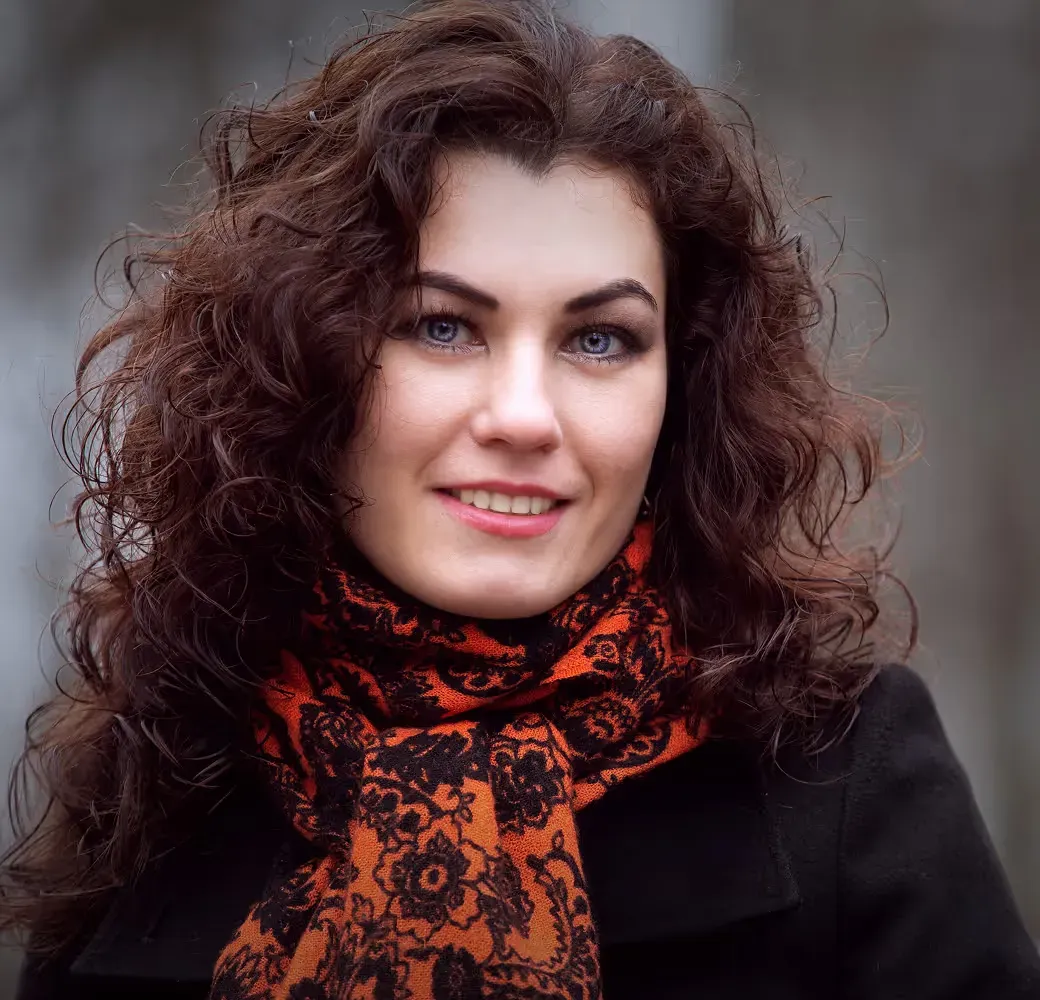 Emily Johnson, a woman with curly brown hair and a patterned scarf