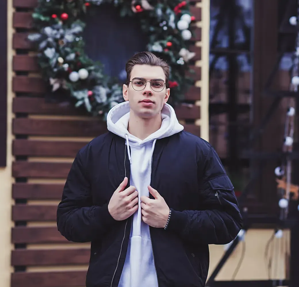 Liam Thompson, a young man with glasses in a dark puffer jacket