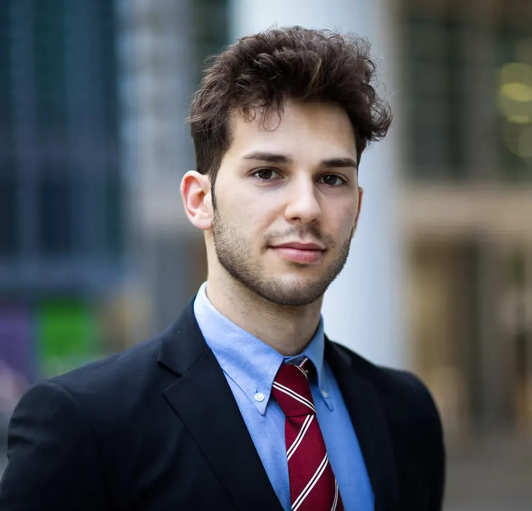 Michael Carter, a young man in a suit and red striped tie